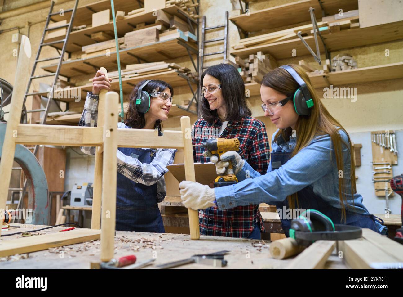 Une équipe diversifiée de travailleurs collabore dans un chantier forestier, en se concentrant sur l'artisanat et le développement des compétences. La scène illustre la formation, le travail d'équipe et la protection des biens Banque D'Images