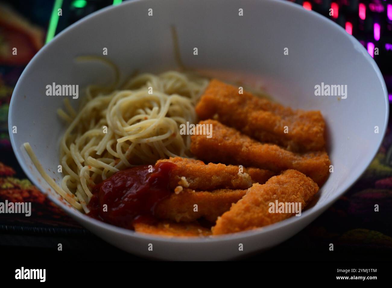 Assiette pleine de spaghettis et de bâtonnets de poisson. Banque D'Images