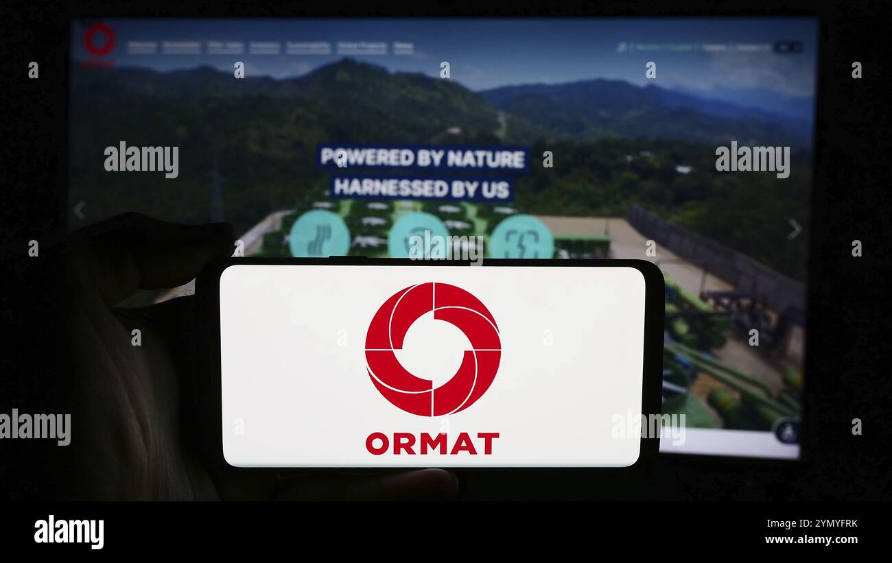 Stuttgart, Allemagne, 07-08-2024 : personne tenant un smartphone avec le logo de la société d'énergie géothermique ormat technologies Inc en face du site web. Concentrez-vous sur Banque D'Images