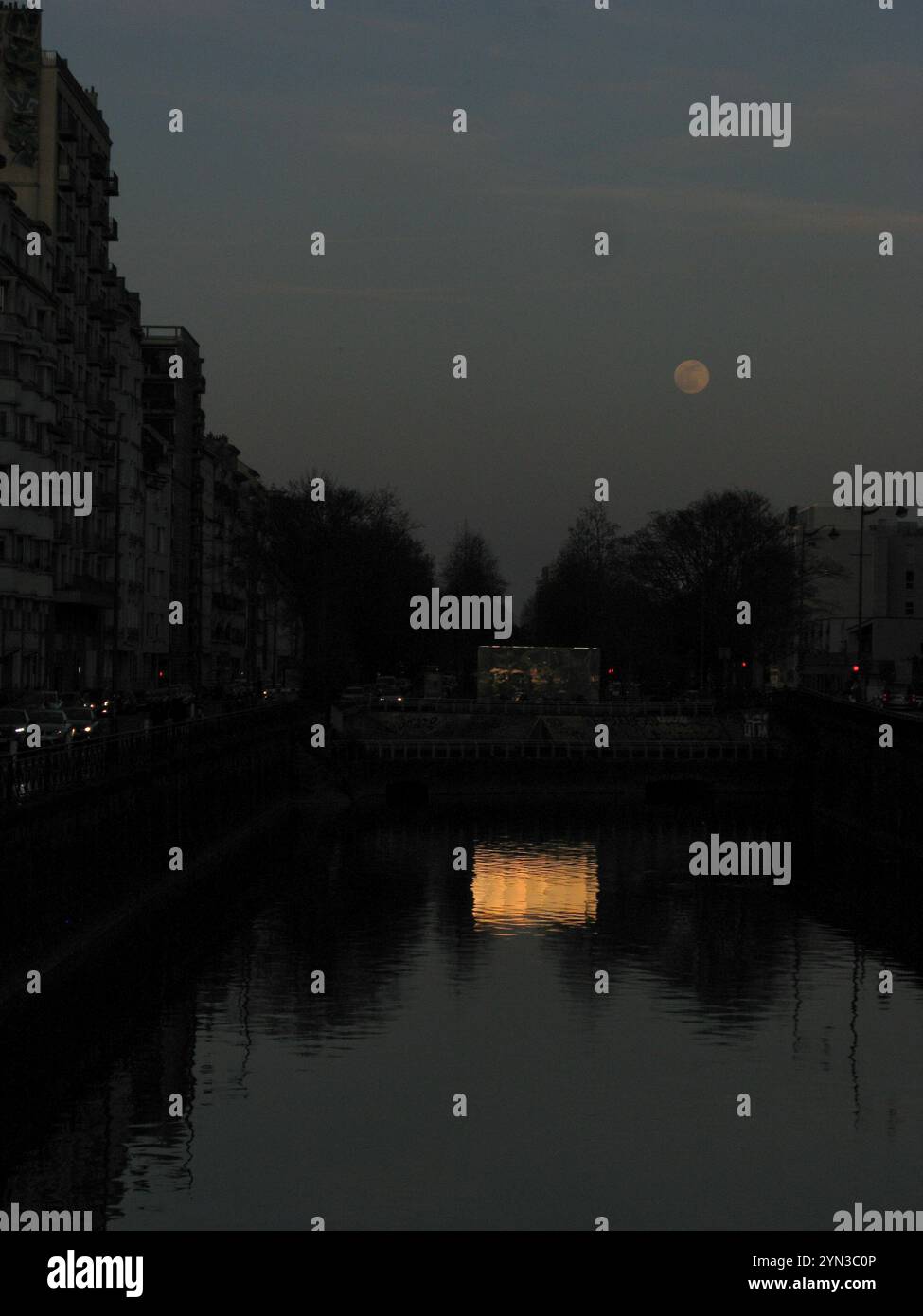 Coucher de soleil rémanente reflétée d'un bâtiment et pleine lune, rivière Vilaine, Rennes Banque D'Images