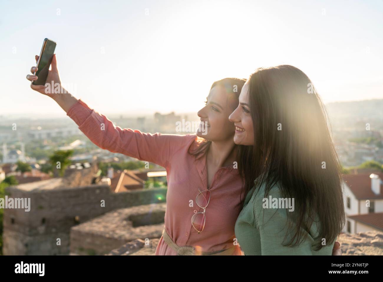 Deux jeunes femmes prenant selfie ensemble dans la ville Banque D'Images