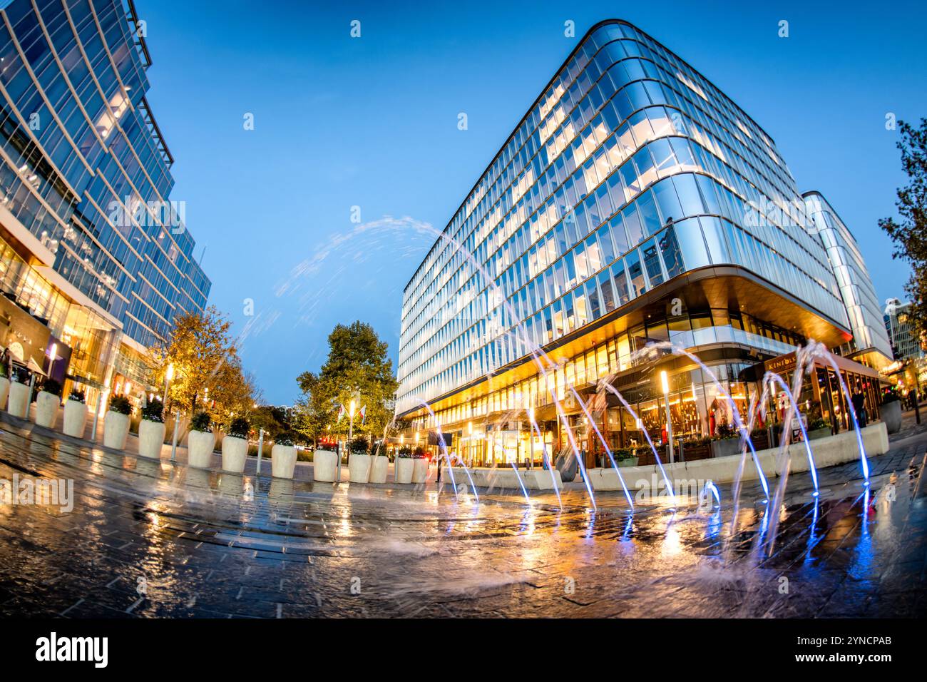 The Wharf Interactive Fountains Washington DC // WASHINGTON DC — des fontaines interactives et des plans d'eau animent les espaces plaza du Wharf, un quartier riverain réaménagé dans le sud-ouest DC, alors que le crépuscule s'installe sur le développement à usage mixte. Les bâtiments modernes encadrent les expositions aquatiques, qui offrent à la fois un attrait esthétique et des espaces de rassemblement publics. Banque D'Images