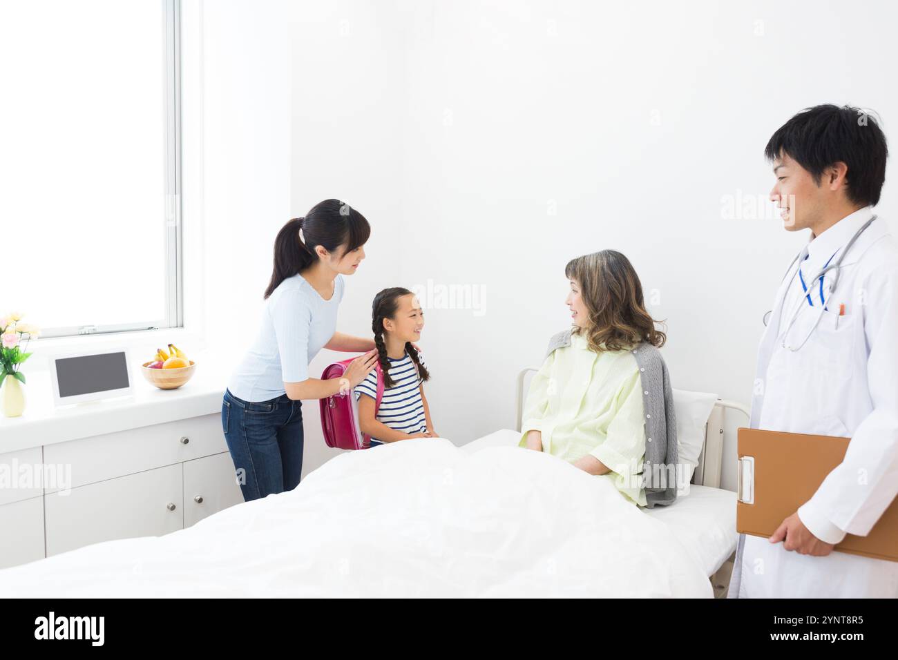 Femme âgée avec des membres de la famille qui sont venus lui rendre visite Banque D'Images