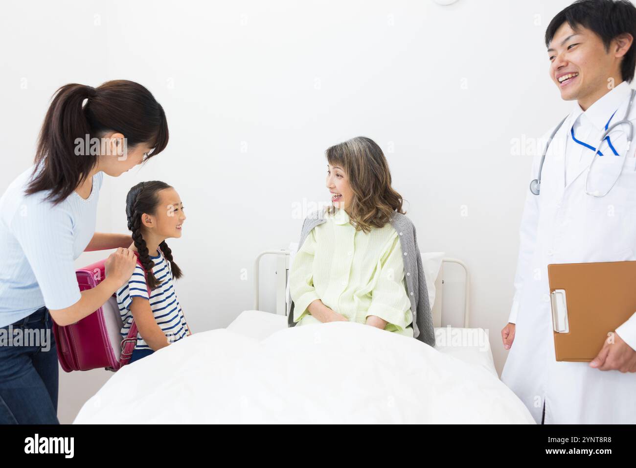 Femme âgée avec des membres de la famille qui sont venus lui rendre visite Banque D'Images