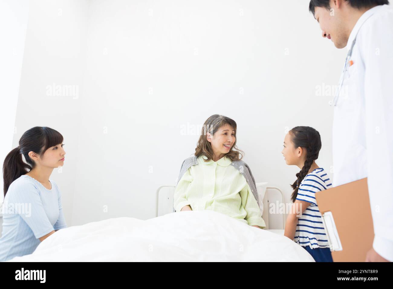 Femme âgée avec des membres de la famille qui sont venus lui rendre visite Banque D'Images