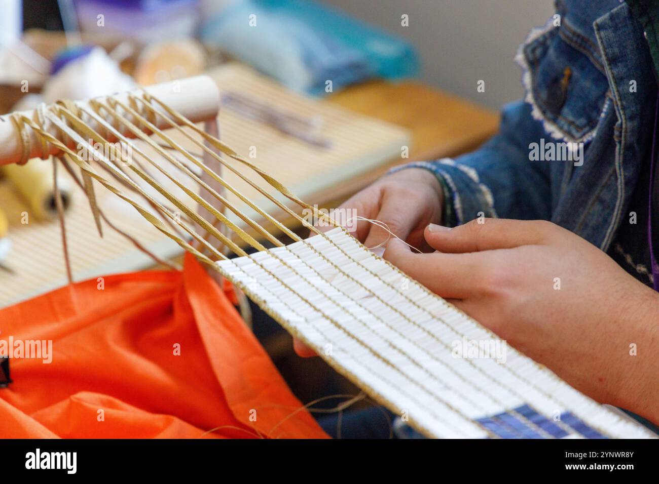 Un artisan indigène créant une ceinture de wampum sur le site historique d'État de Ganondagan à Victor, NYC. Banque D'Images