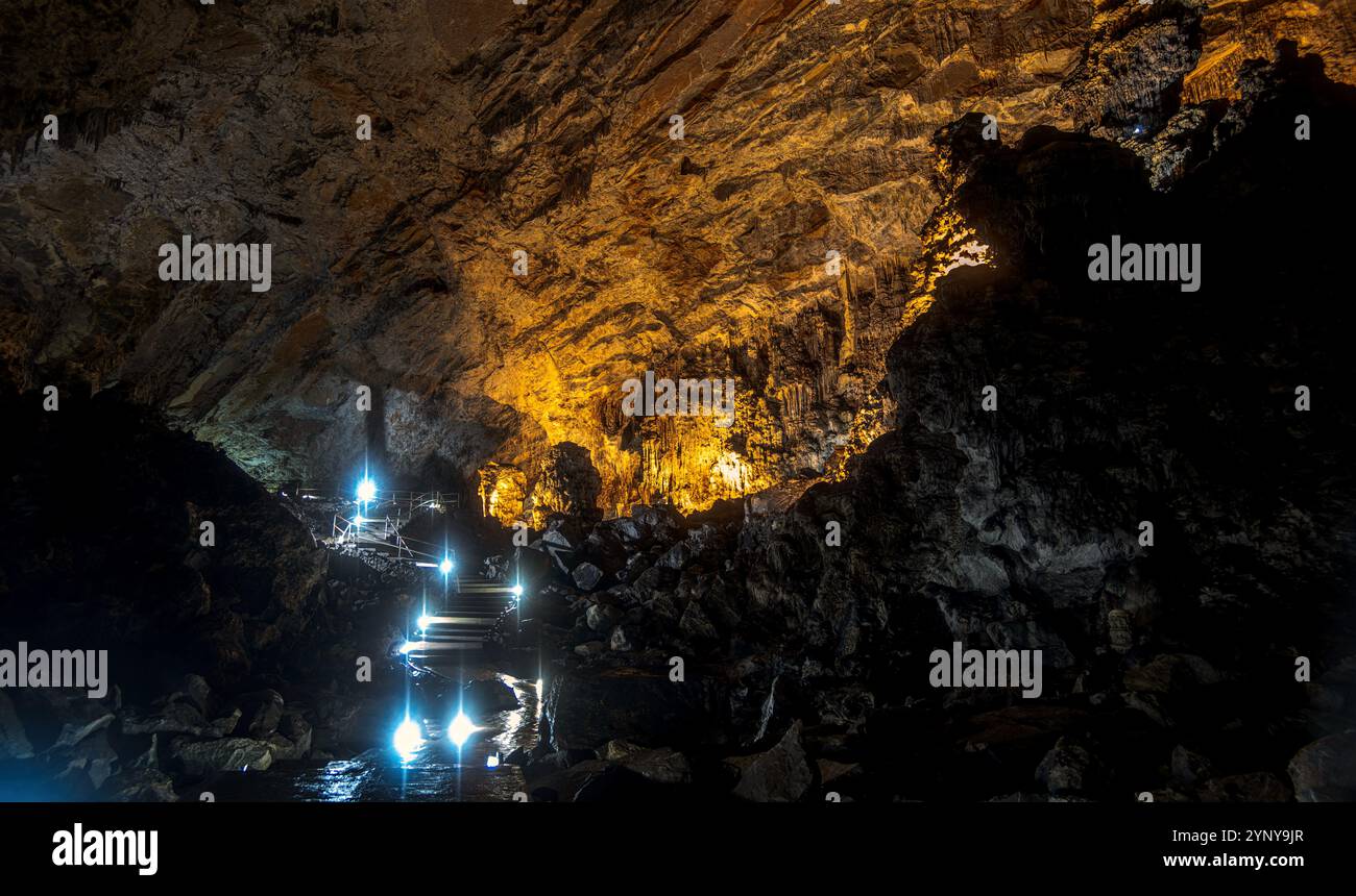 À l’intérieur du Parque Nacional Grutas de Cacahuamilpa, les visiteurs naviguent à travers des espaces caverneux éclairés par un éclairage stratégique. Le formati rock dramatique Banque D'Images