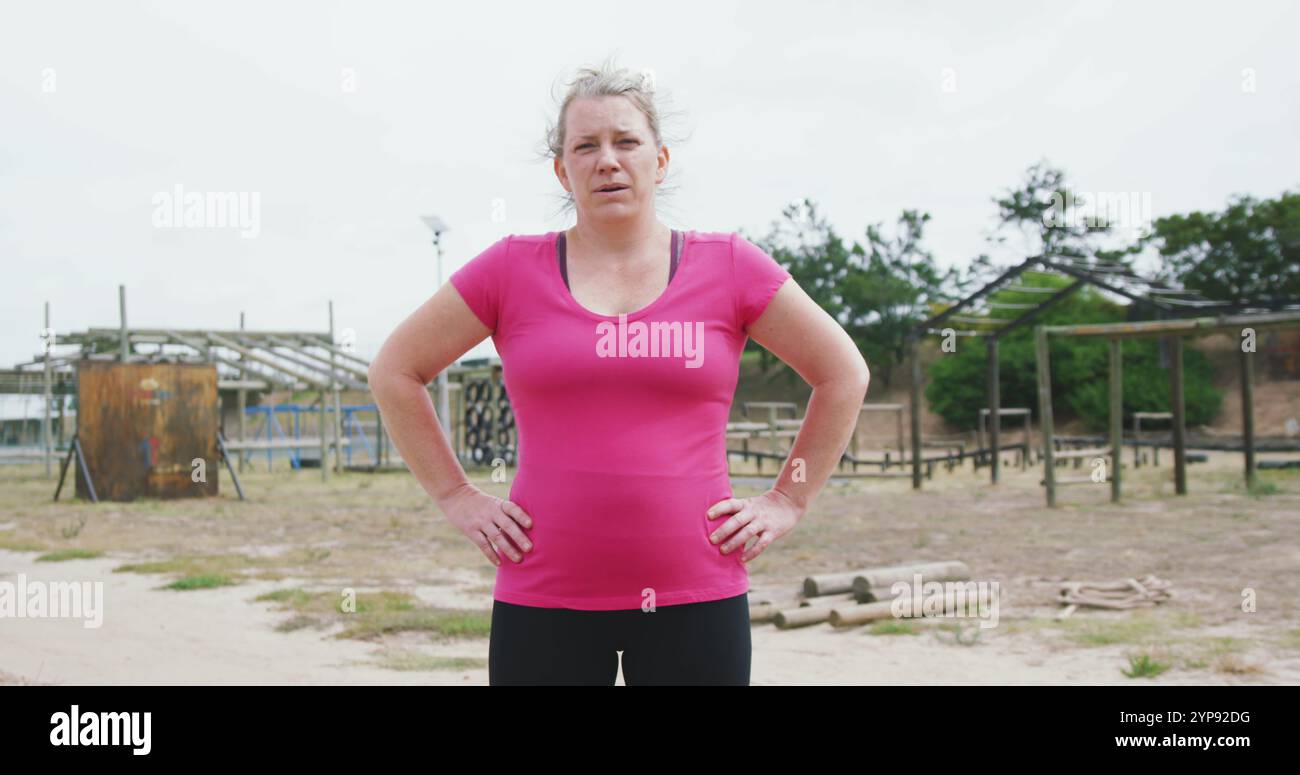 Portrait d'une femme caucasienne debout au camp d'entraînement, regardant la caméra avec les mains sur ses hanches, weari Banque D'Images