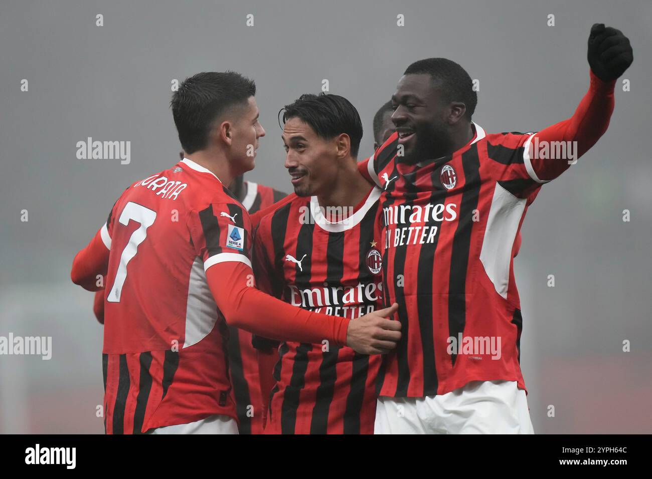 AC Milan's Tijjani Reijnders, center, celebrates with Alvaro Morata, left, and Youssouf Fofana after scoring his side's third goal during the Italian Serie A soccer match between AC Milan and Empoli, at the Milan San Siro stadium, Italy, Saturday, Nov. 30, 2024. (AP Photo/Luca Bruno) Banque D'Images