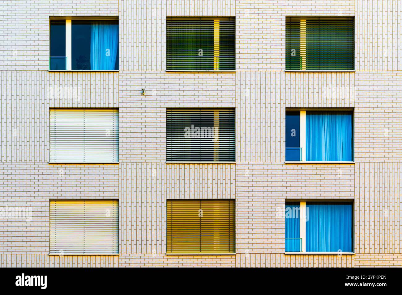 Bâtiment résidentiel minimaliste avec façade blanche propre et fenêtres symétriques sous un ciel clair Banque D'Images