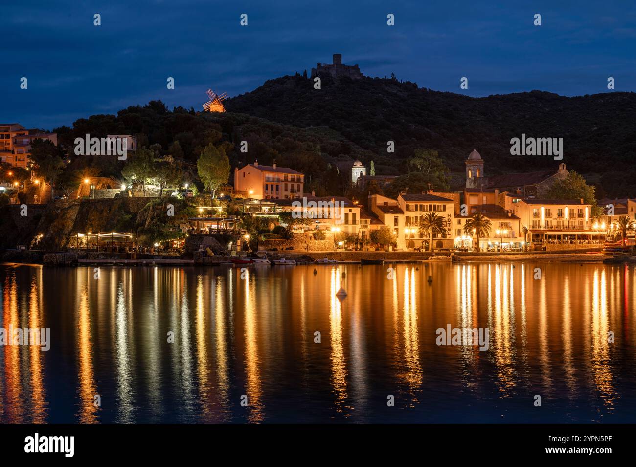 Hôtels illuminés, bars et restaurants sur la promenade de la plage de Collioure en contrebas du Fort Saint-Elme au crépuscule, Languedoc-Roussillion, France Banque D'Images