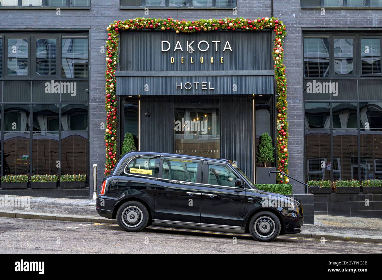 Taxi électrique attendant à l'entrée d'un hôtel Dakota, West Regent Street, Glasgow, Écosse, Royaume-Uni, Europe Banque D'Images