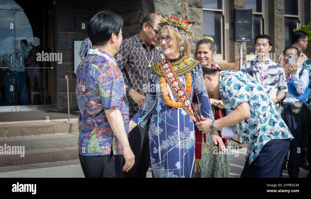 Honolulu, États-Unis. 30 novembre 2024. Le président taïwanais Lai Ching-te, à gauche, présente Dee Jay Mailer, PDG du Bishop Museum, au centre, avec des cadeaux indigènes symbolisant les cultures connexes du peuple océanien, le 30 novembre 2024 à Honolulu, Hawaï. Les articles comprenaient une coiffe, faite par le peuple indigène Paiwan de Taïwan, et des pièces décoratives de cou et d'épaule faites par le peuple indigène Atayal, également de Taïwan. Crédit : Liu Shu Fu/Bureau présidentiel de Taiwan/Alamy Live News Banque D'Images