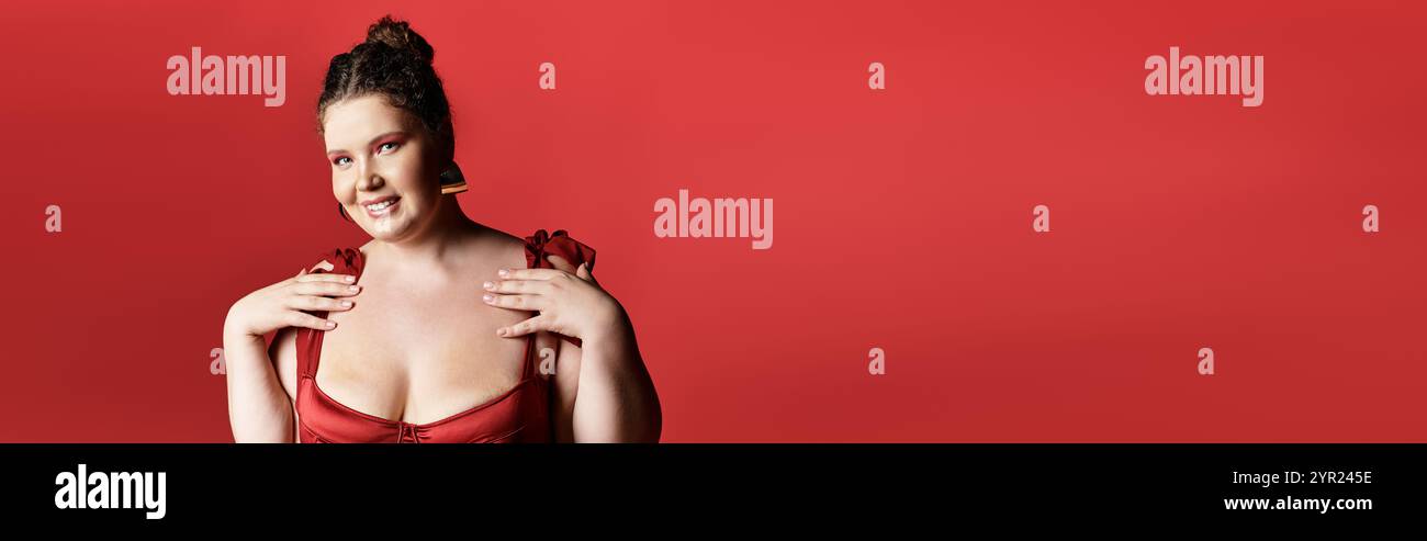 Jeune femme présente la mode tendance dans un ensemble rouge frappant, exsudant charme et confiance. Banque D'Images