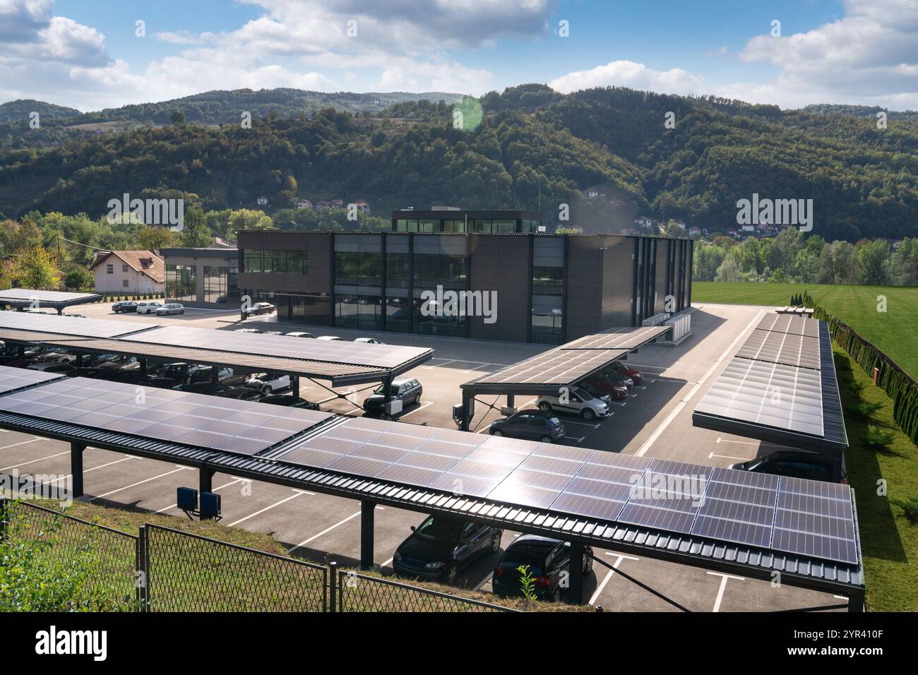 Place de parking avec panneaux solaires sur un toit. Banque D'Images