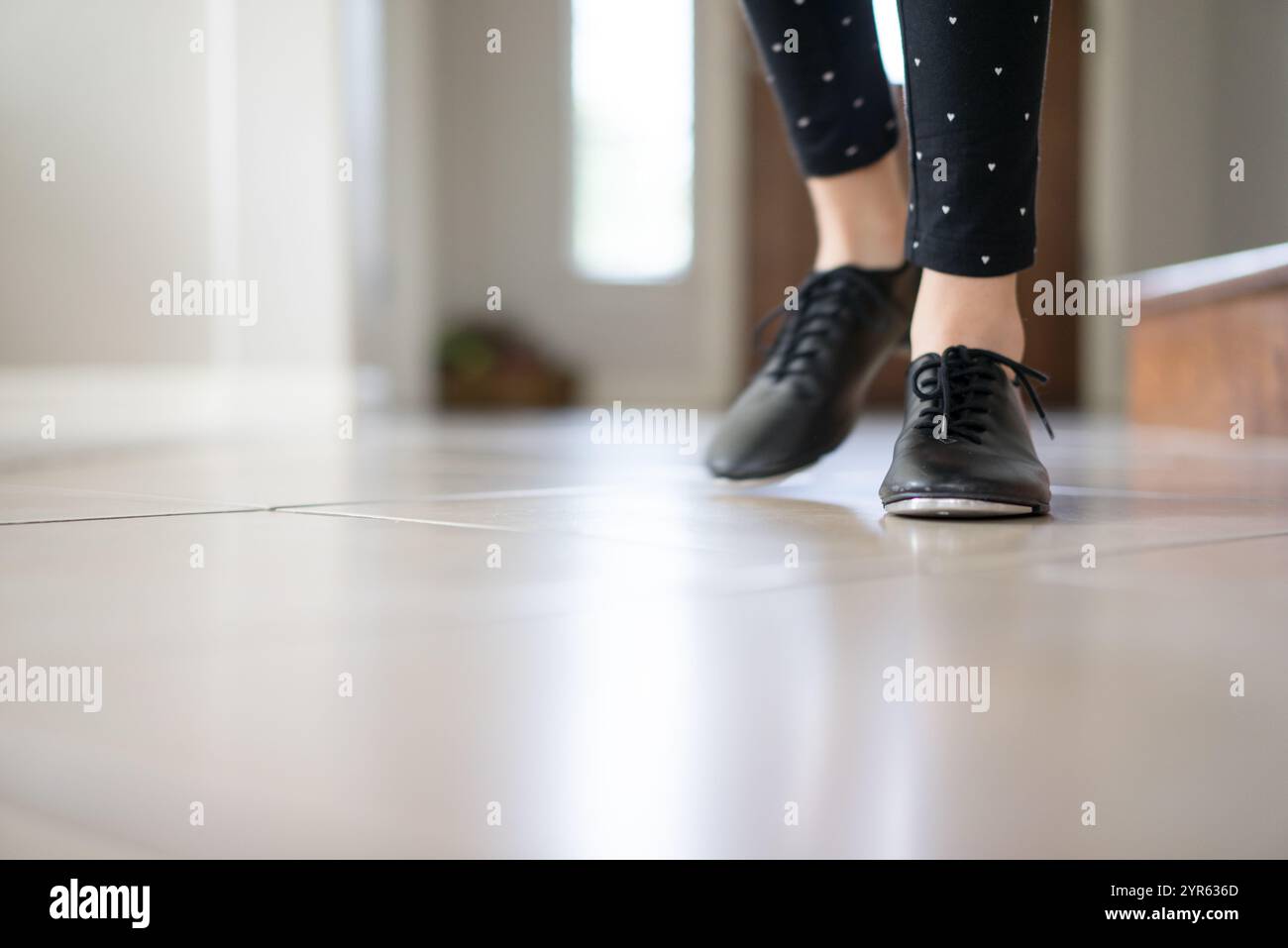 Gros plan des pieds d'une fille portant des chaussures Jazz sur le sol carrelé Banque D'Images