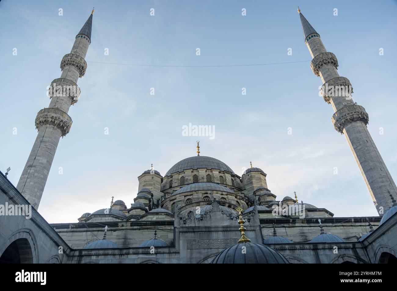 Une vue imprenable sur l'architecture d'une grande mosquée, avec des dômes proéminents et des minarets imposants dans un ciel clair, mettant en valeur le design islamique Banque D'Images