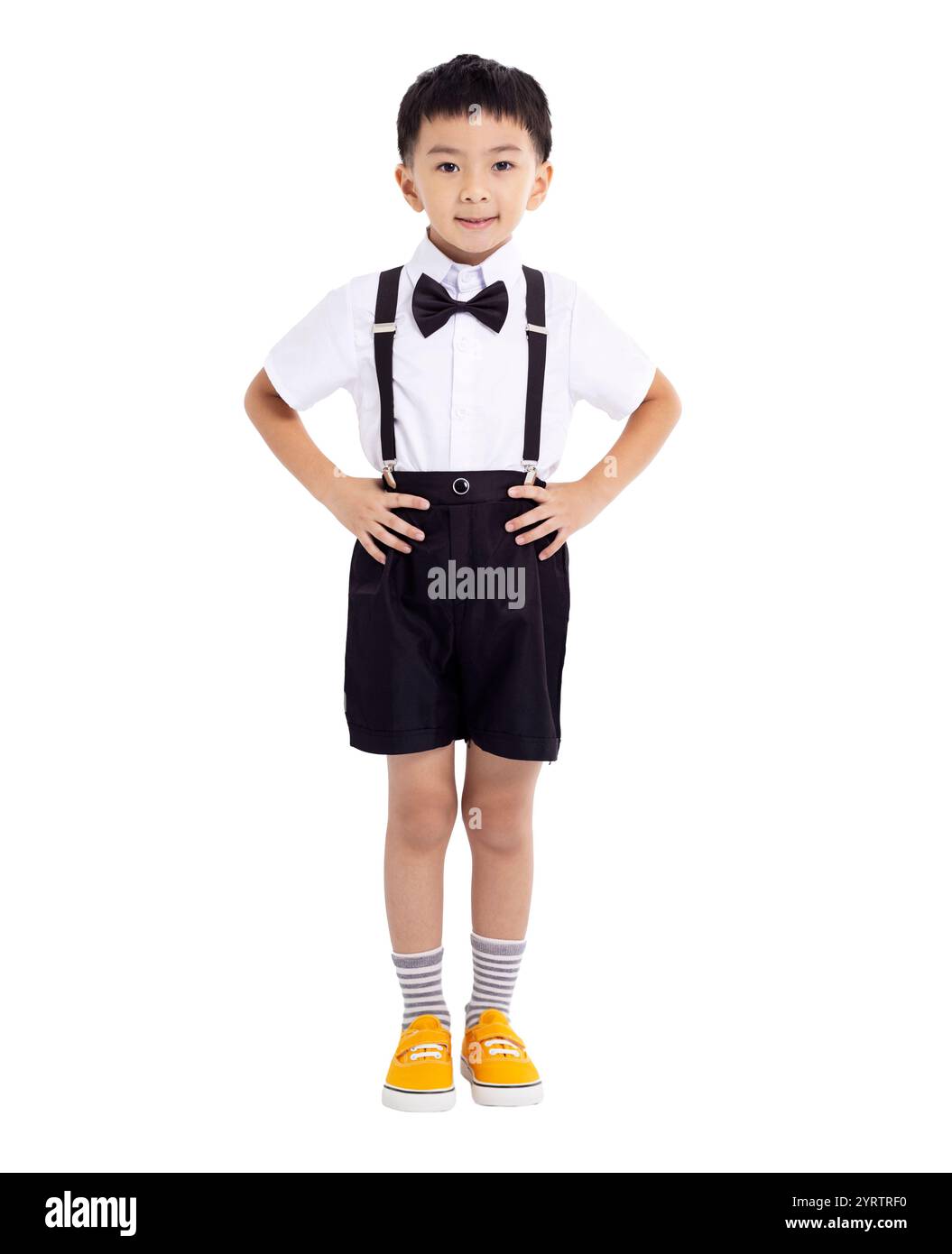 Portrait of smiling boy standing against white background Banque D'Images