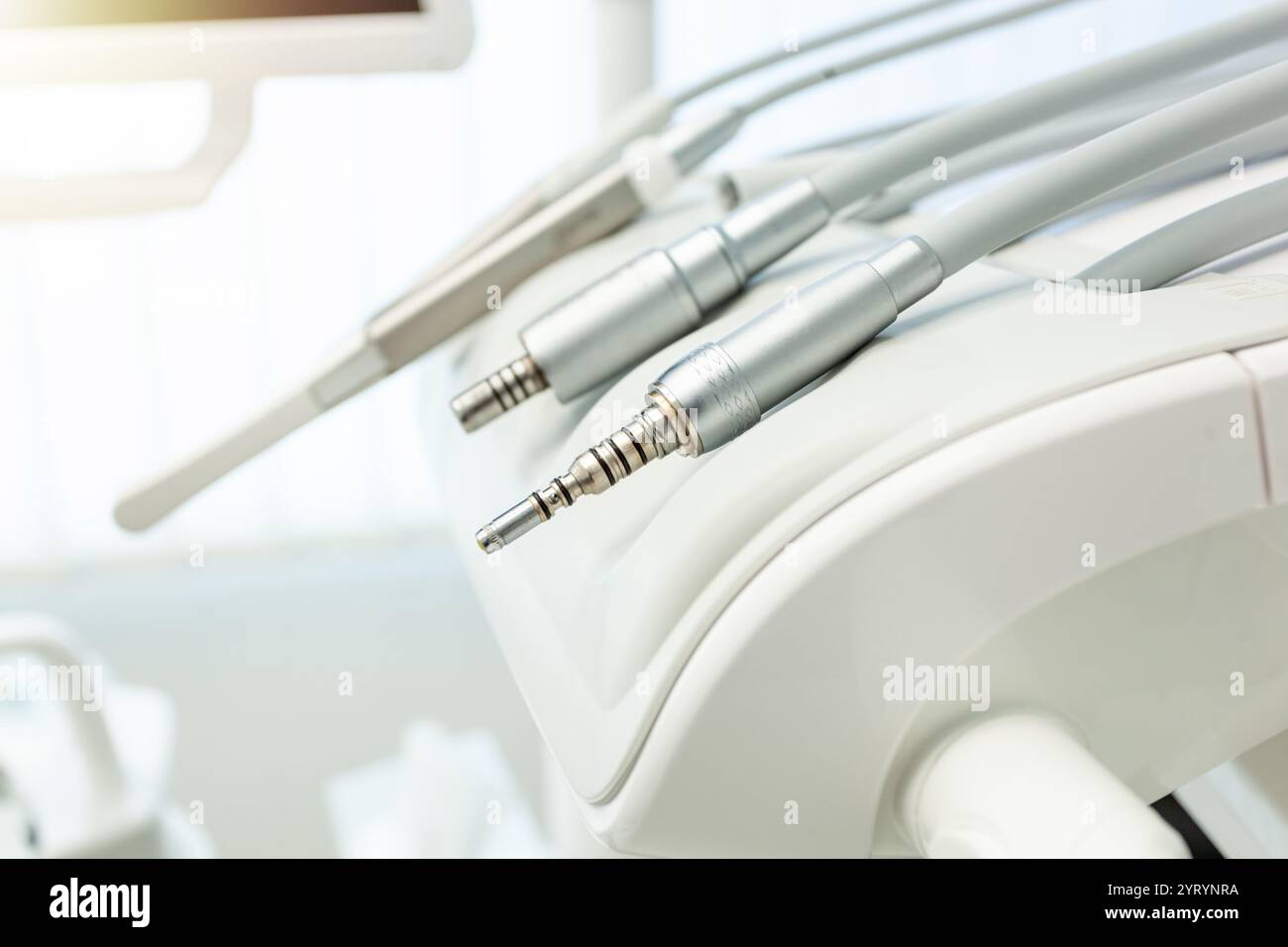 Gros plan de forets dentaires reposant sur un fauteuil de dentiste moderne, mettant en évidence la technologie de pointe et l'environnement stérile des soins dentaires contemporains Banque D'Images