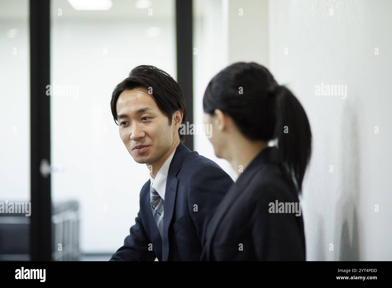 Hommes d'affaires assis sur un banc ayant une conversation Banque D'Images