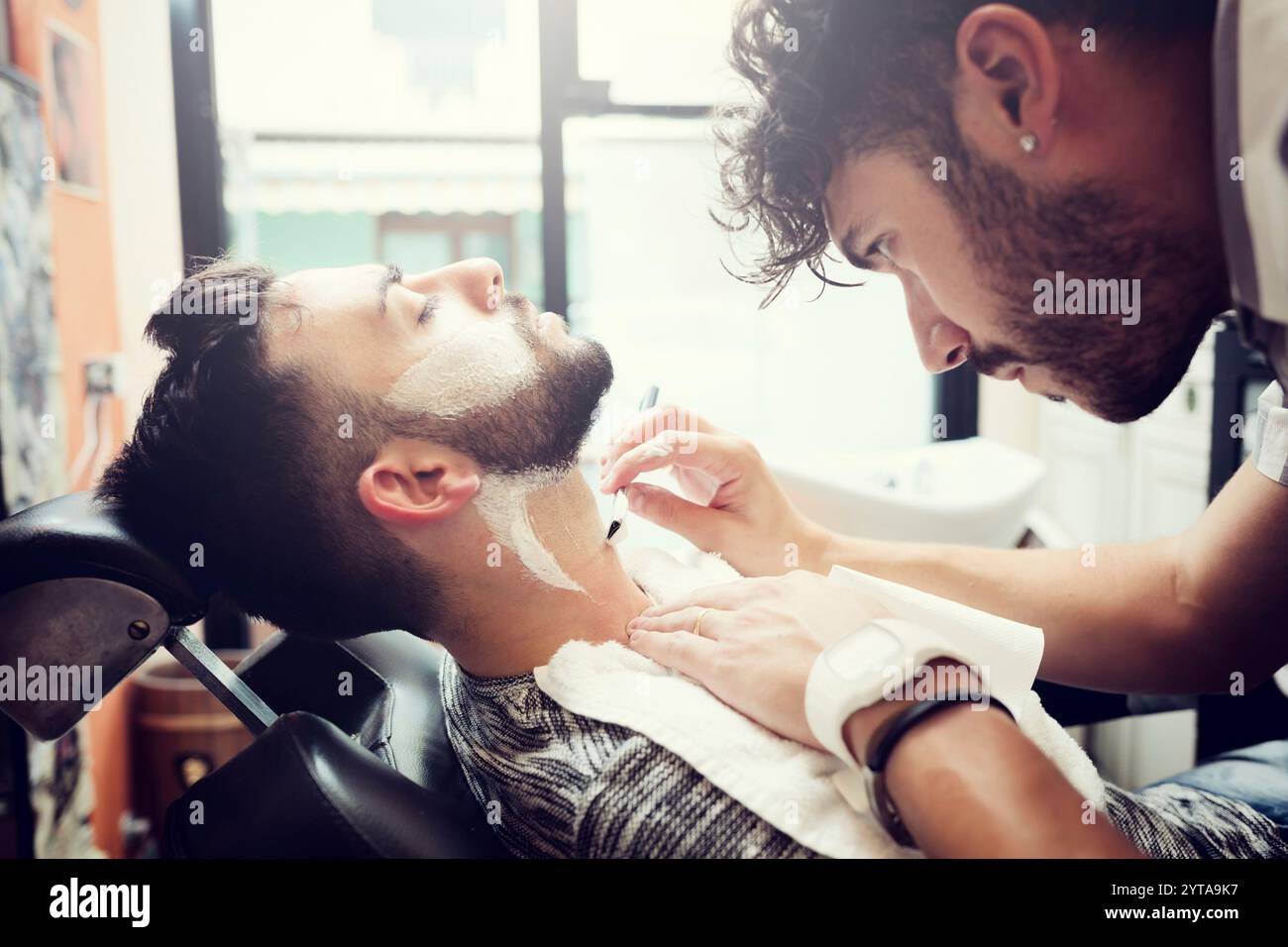 Rituel traditionnel de rasage de la barbe dans un salon de coiffure de style ancien Banque D'Images