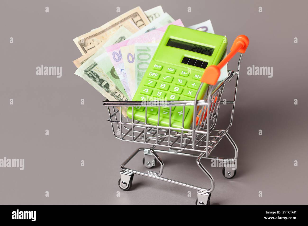 Chariot de panier, Calculatrice verte, argent. Inflation conceptuelle pour les dépenses d'épicerie et le consumérisme. Coût de la vie. Indice des prix à la consommation Banque D'Images