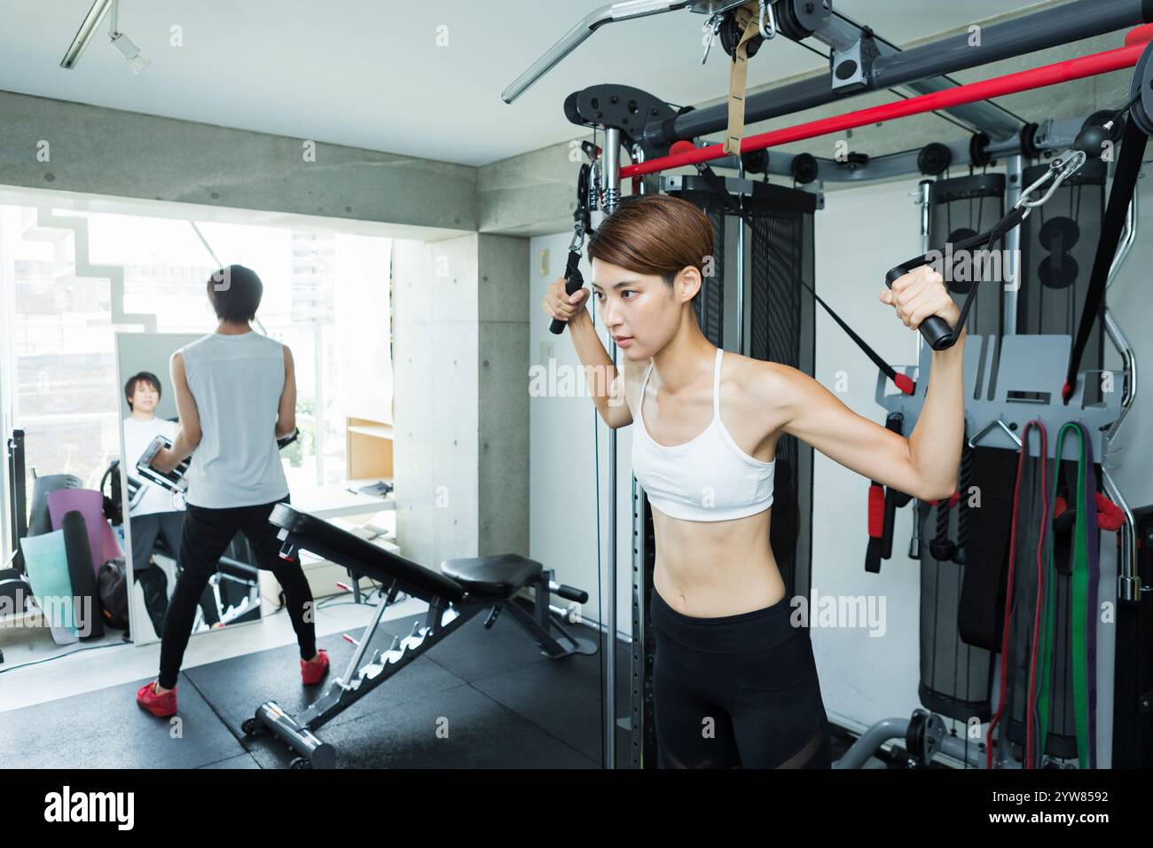 Jeunes hommes et femmes qui s'entraînent au gymnase Banque D'Images