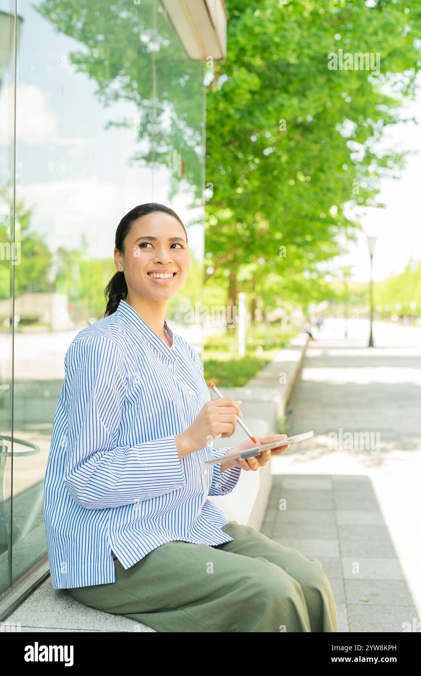 Moitié femme utilisant une tablette à l'extérieur Banque D'Images