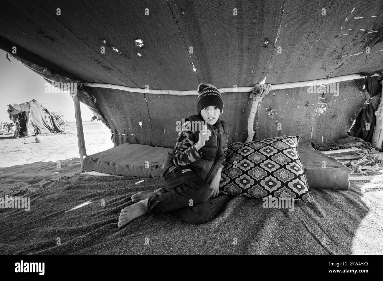 Portrait d'un garçon nomade à l'intérieur d'une tente d'un camp nomade faite de tissu, de bois et de peaux. Concept de liberté, d'enfance et de vie sauvage et différente. Banque D'Images