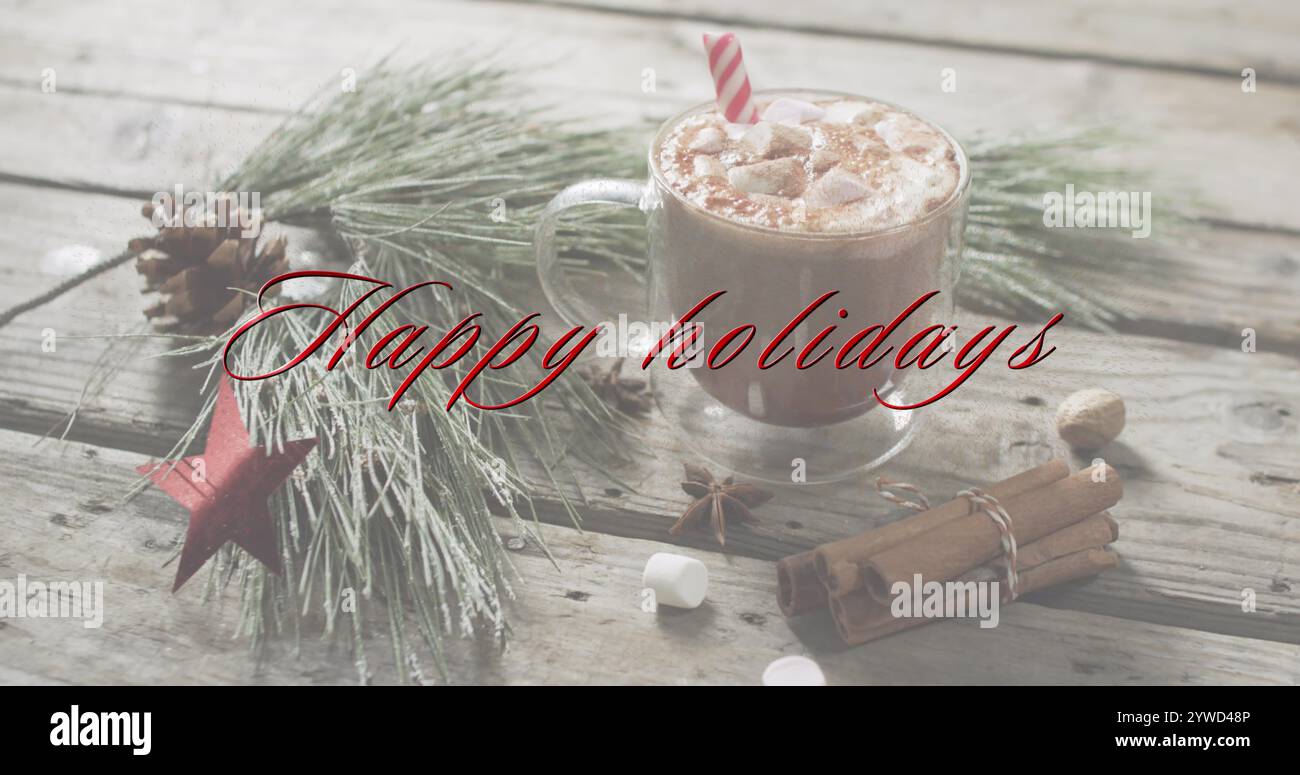 Texte de joyeuses fêtes en rouge sur décorations de noël et chocolat chaud avec guimauves Banque D'Images