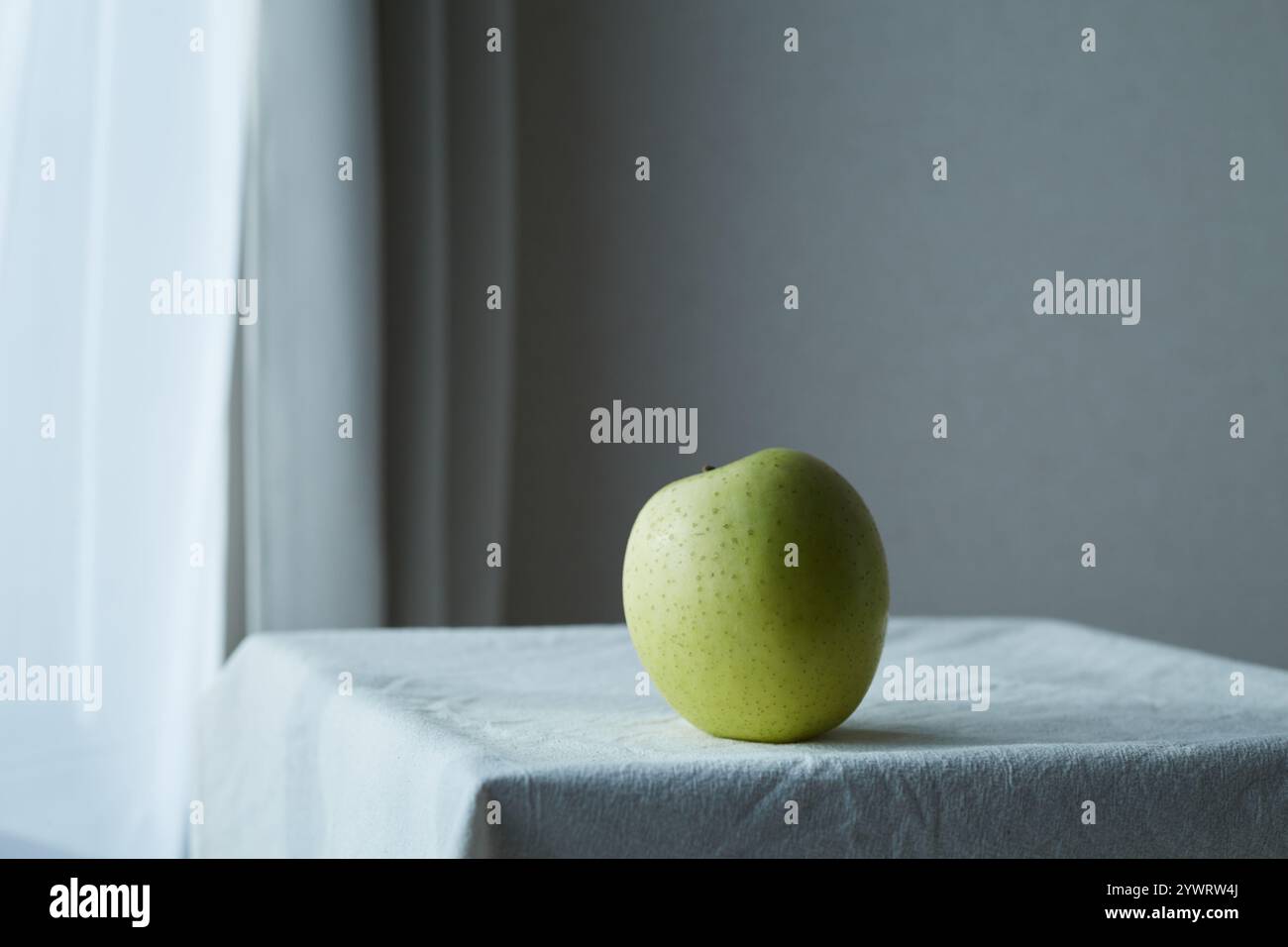 Pommes vertes sur un tissu blanc sur la table Banque D'Images