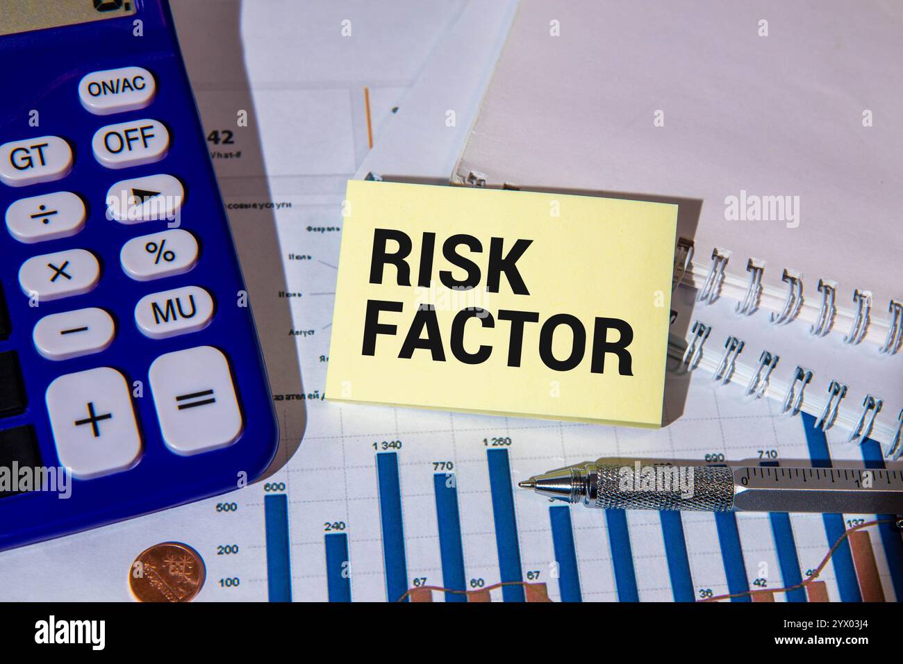 FACTEUR DE RISQUE - mots dans un cahier avec des crayons et une loupe Banque D'Images