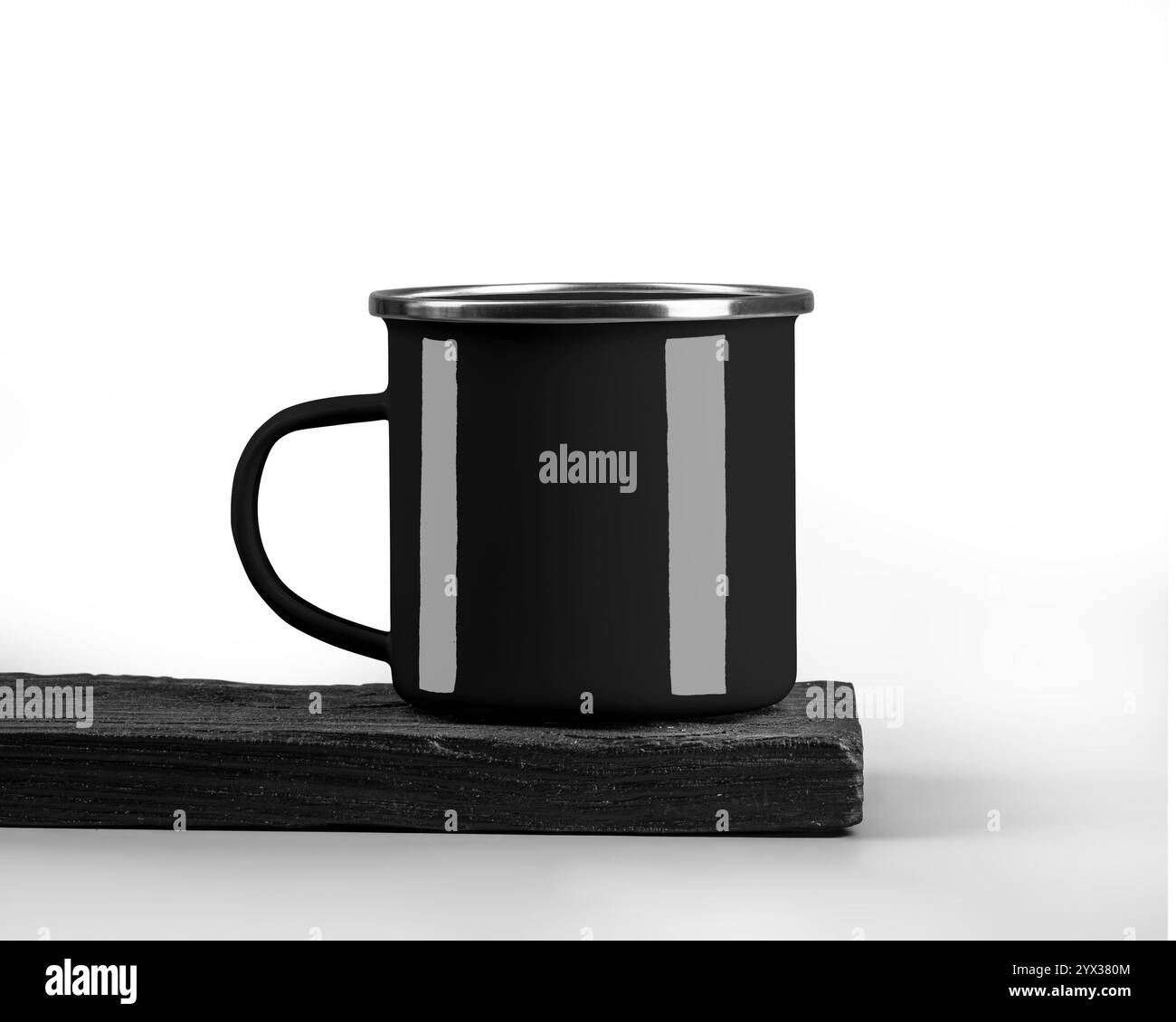Maquette de tasse en émail noir sur bord de planche de bois brûlé texturé, avec rebord argenté, poignée, isolé sur fond. Modèle de tasse de fer pour la conception, son Banque D'Images