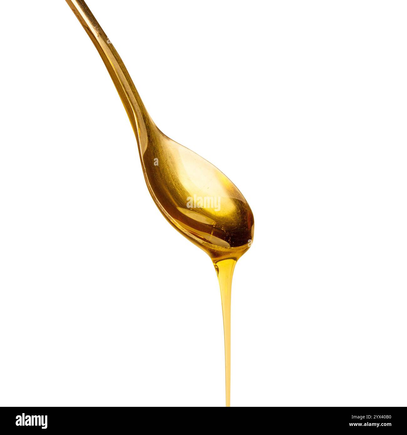 Cuillère avec du miel coulant sur fond vide Banque D'Images