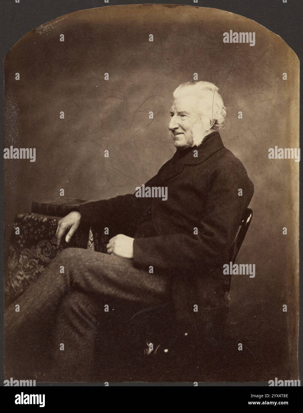 Portrait d'un homme, vue 3/4, vers 1852-1862. Informations supplémentaires : Portrait d'un homme assis en 3/4 vue portant un manteau noir avec sa main reposant sur une table tenant un grand livre relié en cuir. Banque D'Images