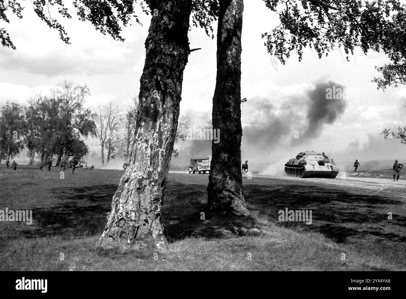 Russie 1944 : soldats allemands fuyant une attaque russe à côté de la piste Moscou-Minsk. La photo a été prise lors des combats de l'offensive russe (opération Bagration) dans la partie centrale du front de l'est. Sur la droite sur la route se trouve un T34 russe capturé avec une barre transversale. [traduction automatique] Banque D'Images