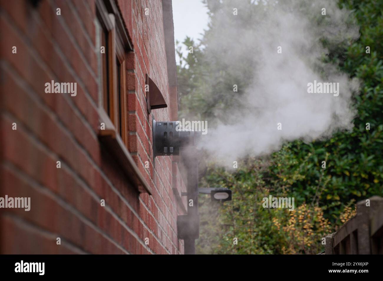 panache de vapeur sortant de l'évent d'échappement d'une chaudière de chauffage central à condensation au mazout, norfolk rural, angleterre Banque D'Images