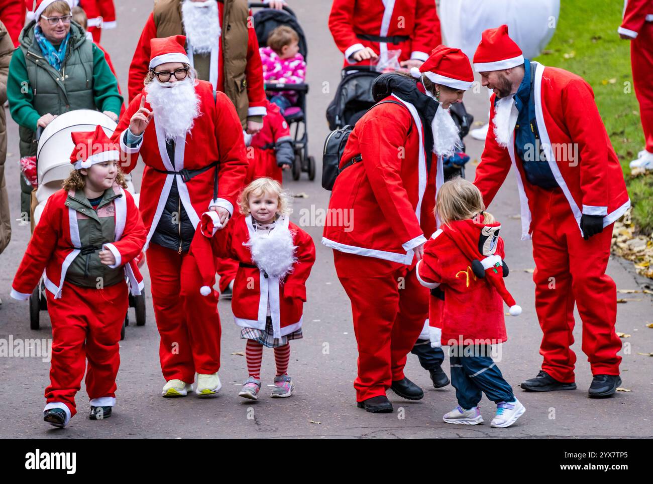 Les enfants s'amusent à courir dans les costumes du Père Noël, Santa Fun Run ou DASH, Princes Street Gardens, Édimbourg, Écosse, Royaume-Uni Banque D'Images