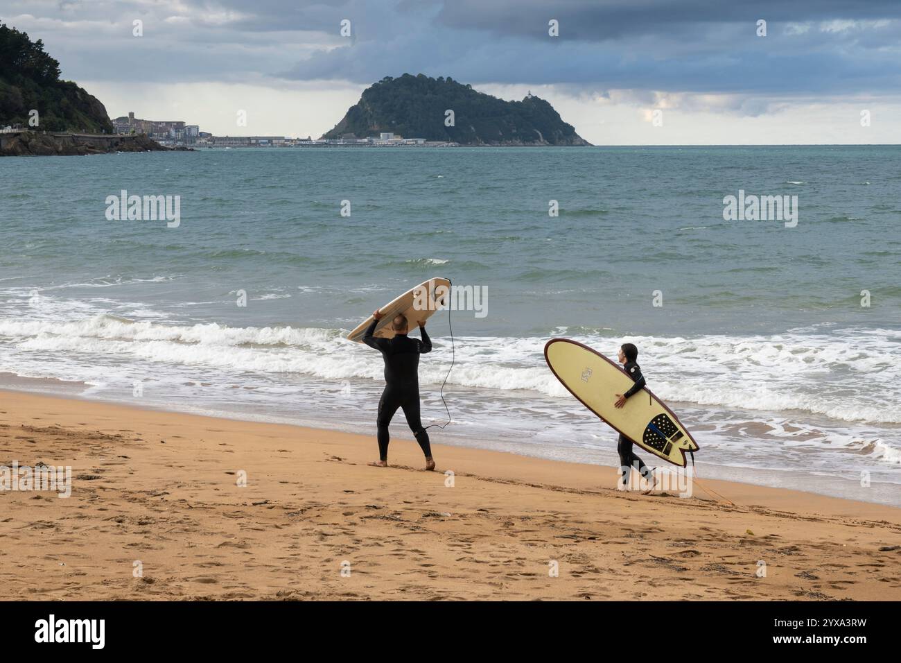 Les surfeurs se préparent à attraper les vagues à Playa de Zarautz à Zarautz, pays Basque, Espagne. Le village balnéaire populaire se trouve le long de la route de Camino del Norte Banque D'Images