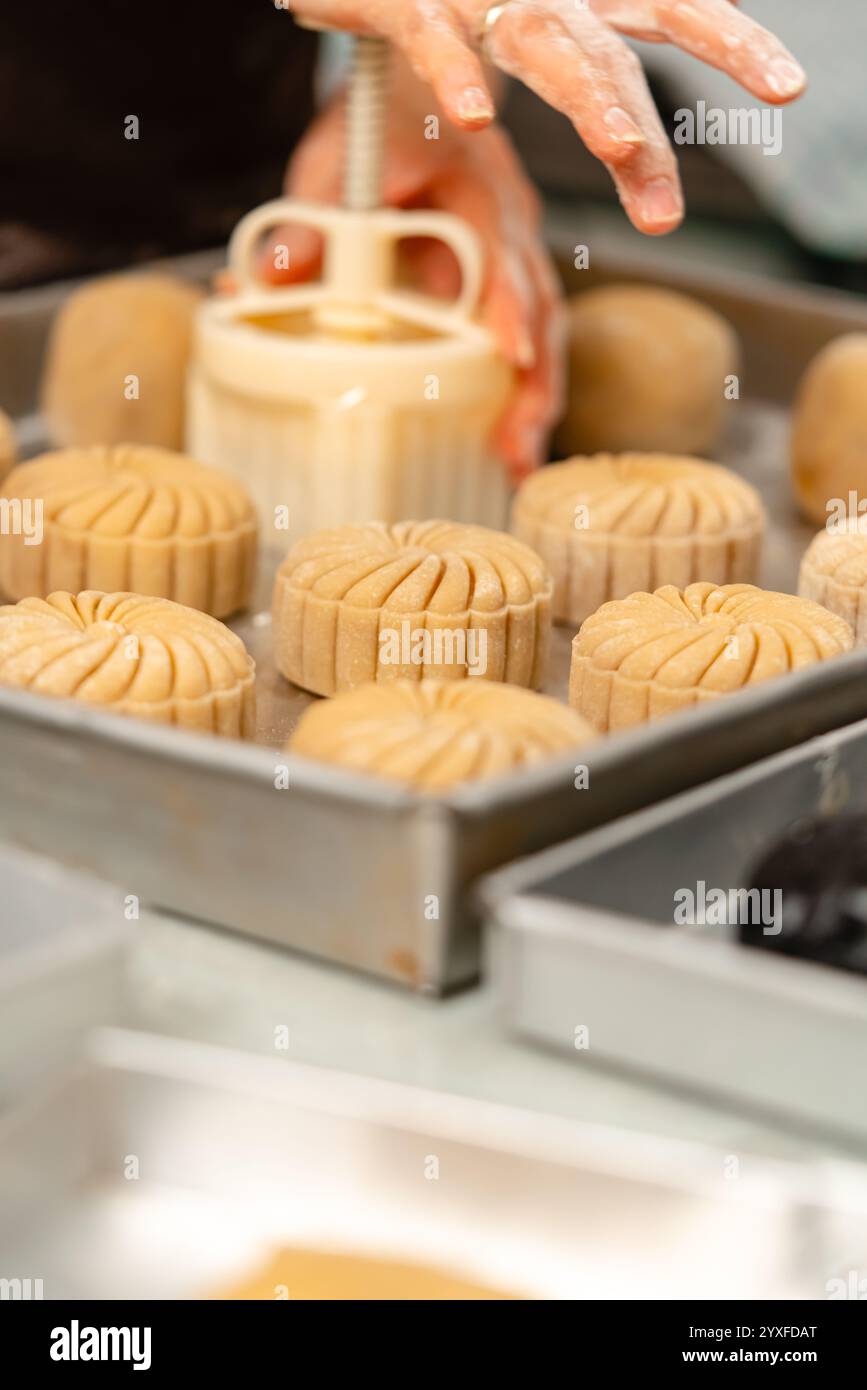 Procédé de fabrication de gâteaux de lune. Un gâteau de lune est un produit de boulangerie chinois traditionnellement consommé pendant le festival de la mi-automne. Banque D'Images