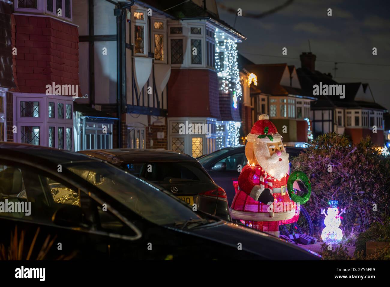 Lower Morden Lane, Surrey, Royaume-Uni. 19 décembre 2024. Les résidents de cette rue résidentielle du sud de Londres décorent l’extérieur de leur maison chaque année, amassant des fonds pour le St Raphael’s Hospice localement qui offre des soins palliatifs et de fin de vie aux habitants de Merton et Sutton. Cette année, ils ont créé une extravagance d'un quart de mile de long de lumières dans les jardins de devant, visités chaque soir par les familles qui apprécient le spectacle. Crédit : Malcolm Park/Alamy Live News Banque D'Images