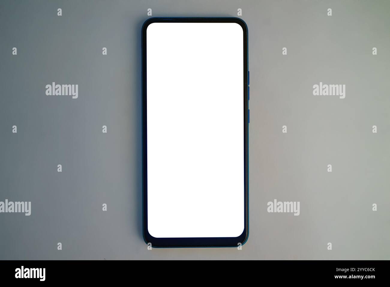 Un smartphone élégant est positionné sur une surface lisse et de couleur neutre, affichant un écran complètement vierge. Cette disposition met l'accent sur le dispositif Banque D'Images