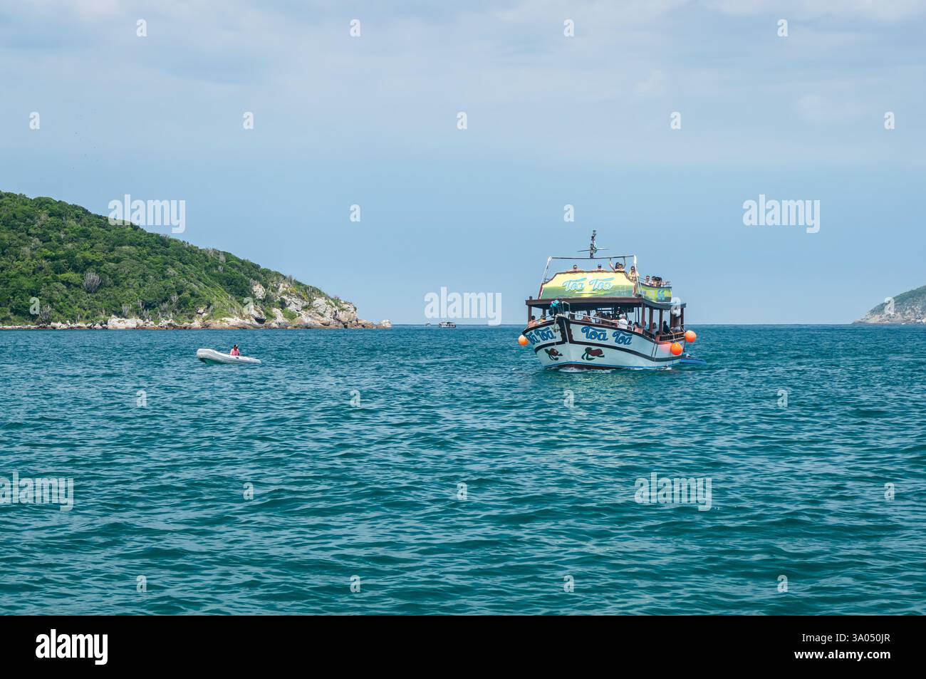 Toa Toa voilier approchant les eaux bleues de la baie de Forno Cove entourées de collines verdoyantes sous un ciel nuageux ensoleillé ensoleillé d'été, Banque D'Images Toa Toa voilier approchant les eaux bleues de la baie de Forno Cove entourées de collines verdoyantes sous un ciel nuageux ensoleillé ensoleillé d'été, Banque D'Images