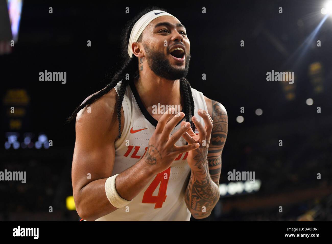 Illinois guard Kylan Boswell reacts after losing control of a rebounded ball during the second half of an NCAA college basketball game against Michigan, Sunday, March 2, 2025, in Ann Arbor, Mich. (AP Photo/Jose Juarez) Banque D'Images