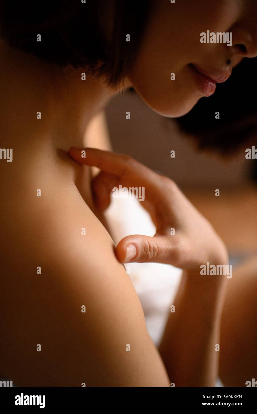 femme portrait gros plan avec des fleurs roses près du visage Banque D'Images