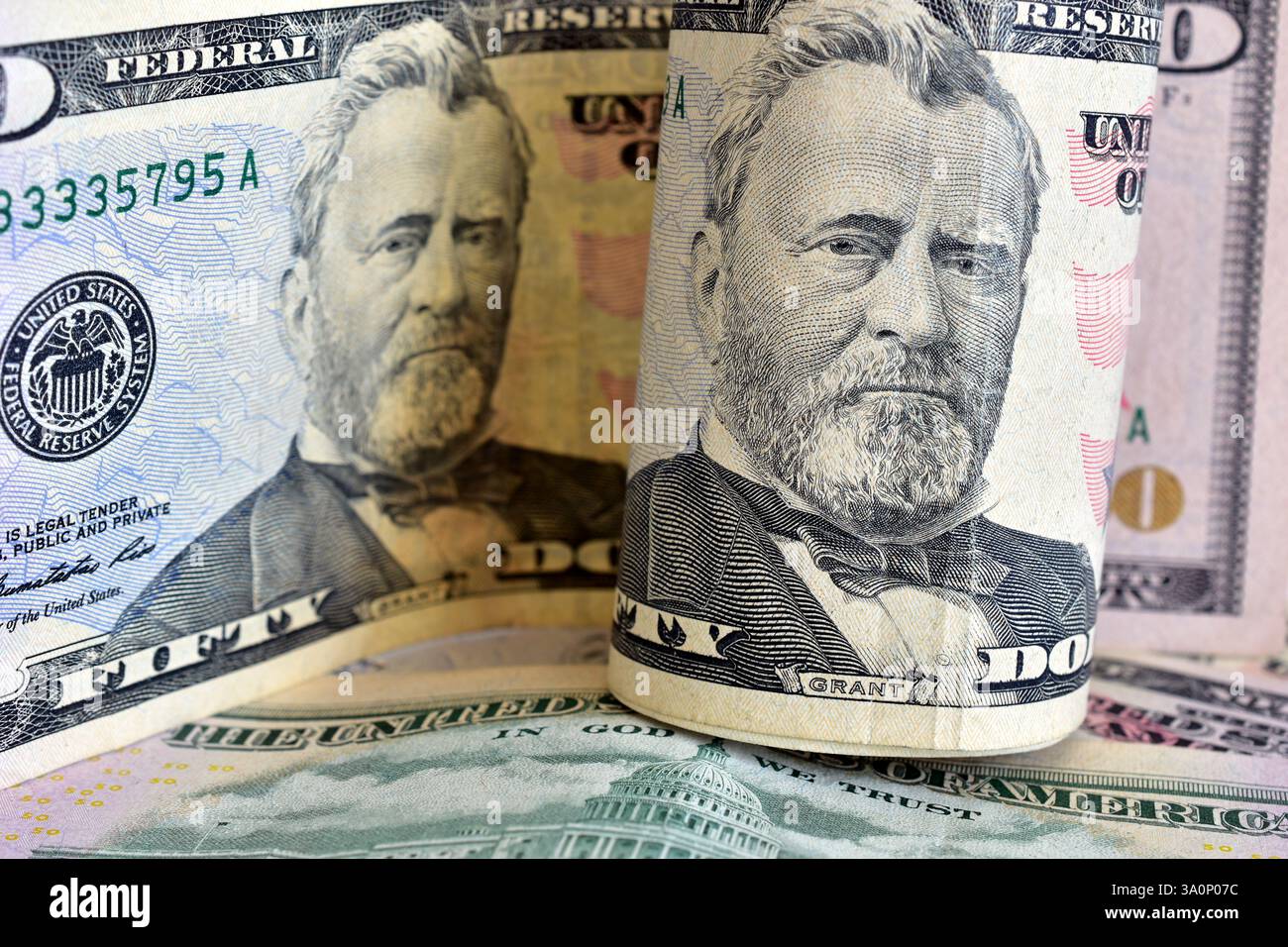 Espèces. Dollars américains roulés en rouleaux avec un portrait du président, gros plan, sur fond blanc. Banque D'Images