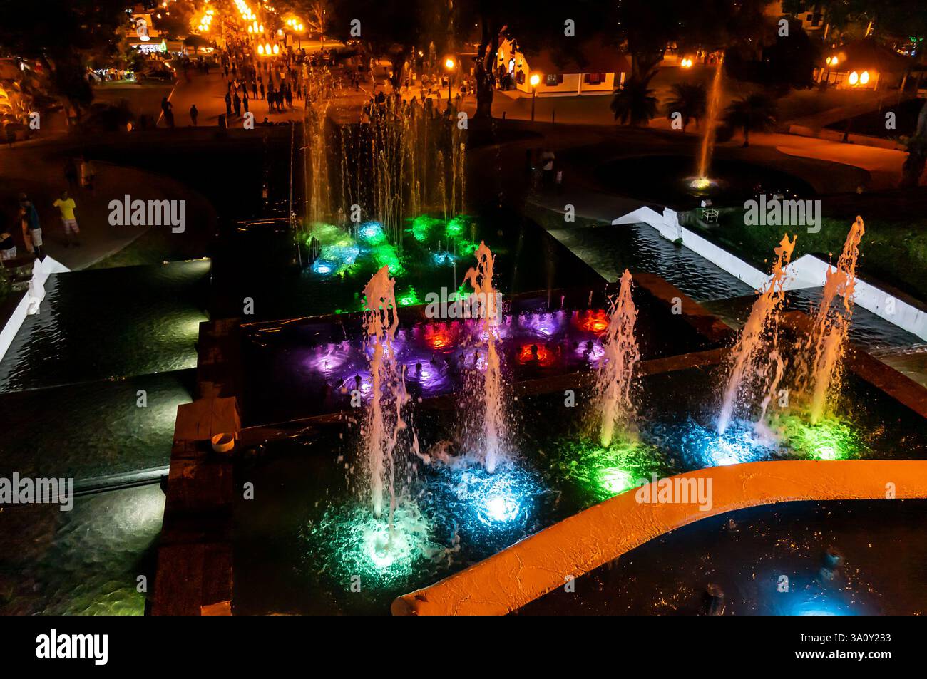 Fontaine lumineuse vibrante sur le côté nord de la place Menino João Helio au milieu du parc public sous une nuit d'été chaude et animée. Banque D'Images