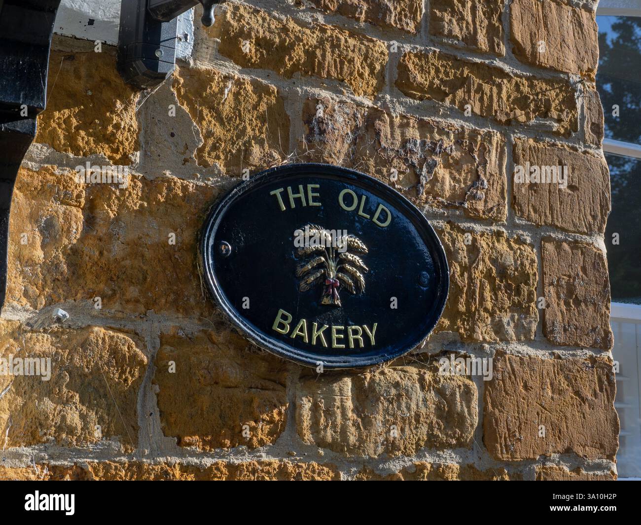Panneau de maison ovale mural en métal pour The Old Bakery, Milton Malsor village, Northamptonshire, Royaume-Uni Banque D'Images