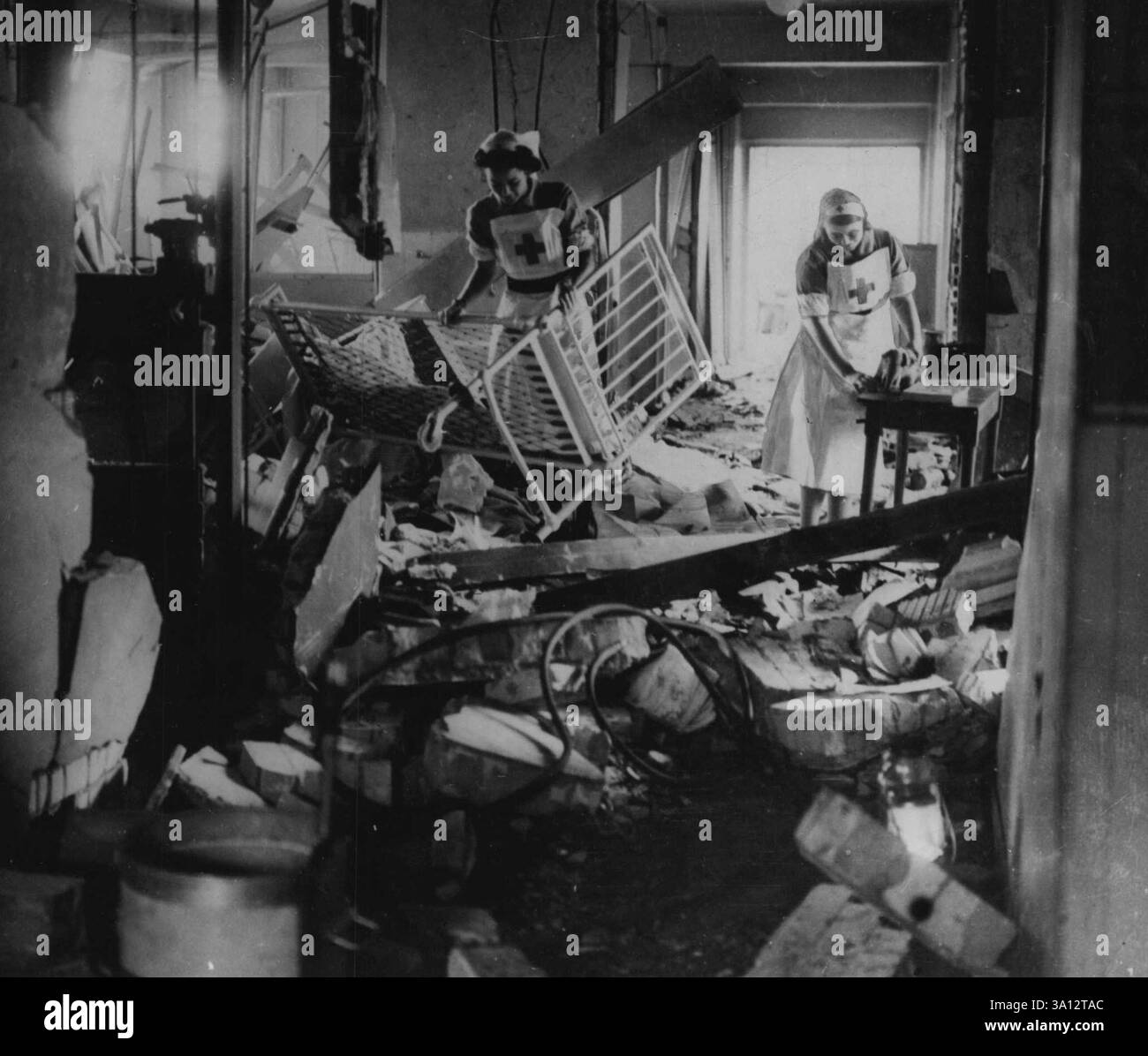 Hôpital bombardé. Des infirmières nettoyant les débris dans la salle d'un hôpital pour enfants après un bombardement allemand sur Londres. 28 octobre 1940. (Photo du Département de l'information du Commonwealth). Banque D'Images