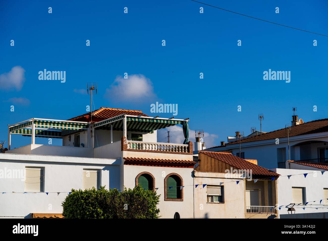 Prélassez-vous dans le soleil côtier espagnol lumineux : terrasse sur le toit dynamique dans le cadre estival blanchi à la chaux de Montril pour une escapade idyllique de vacances en Méditerranée Banque D'Images